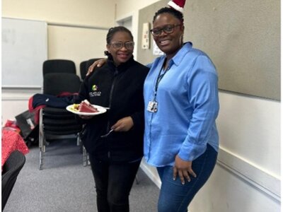 Christmas Party 2024 - Two team members enjoying the celebration