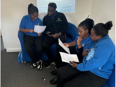 The Clover Way October 2024 - Staff engaged in supportive group discussion and peer support session